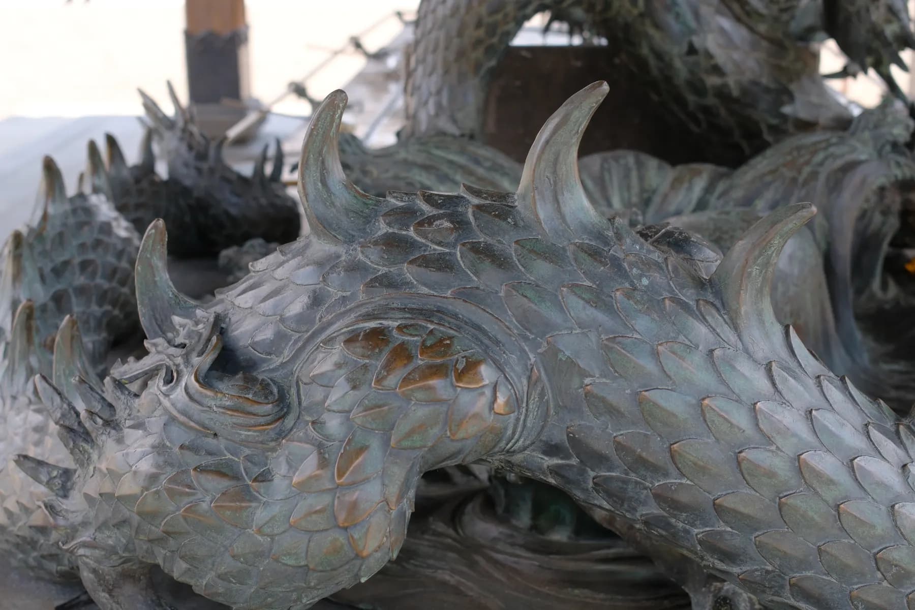 Close-up of a detailed dragon sculpture with scales and horns