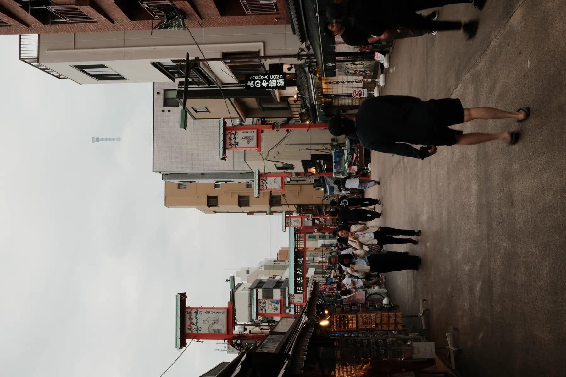 A bustling street scene with people walking and interacting in a vibrant urban setting